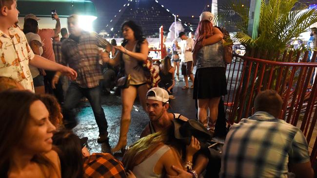 LAS VEGAS, NV - OCTOBER 01: People run for cover at the Route 91 Harvest country music festival after apparent gun fire was heard on October 1, 2017 in Las Vegas, Nevada. There are reports of an active shooter around the Mandalay Bay Resort and Casino. David Becker/Getty Images/AFP == FOR NEWSPAPERS, INTERNET, TELCOS &amp; TELEVISION USE ONLY ==