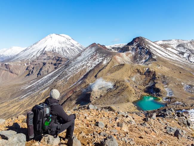 ESCAPE: NEW ZEALAND .. John Corbett story .. Hiker looking at volcanic landscape, New Zealand. Picture: Getty