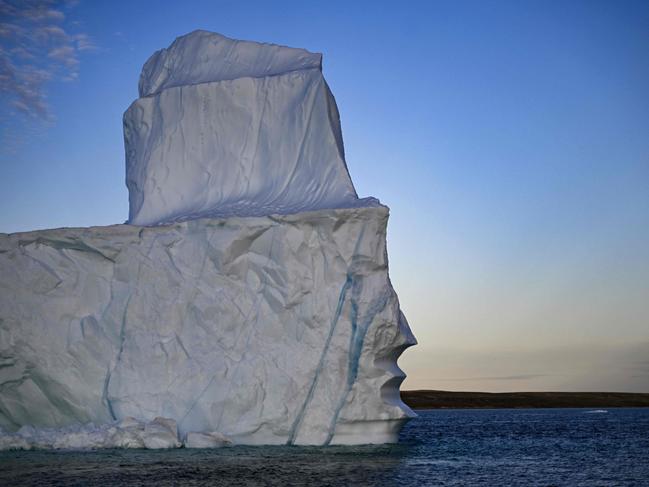 A melting iceberg drifts due to high temperatures in Scoresby Fjord near Ittoqqortoormiit, Greenland, on August 12, 2023. The French National Centre for Scientific Research (CNRS) is undertaking an expedition to explore Greenland's isolated fjords, the planet's largest fjord system, which remains vastly understudied. The expedition, arranged by the volunteer-run French initiative Greenlandia, is dedicated to understanding the climate change's effects on Scoresby Fjord and its inhabitants. (Photo by Olivier MORIN / AFP)