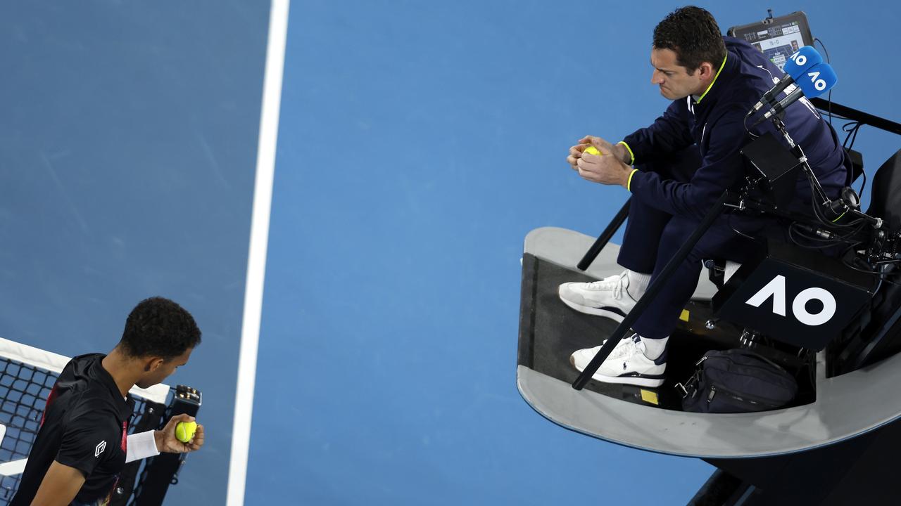 Felix Auger-Aliassime questions the chair umpire about the condition of the Dunlop balls. Picture: Darrian Traynor/Getty