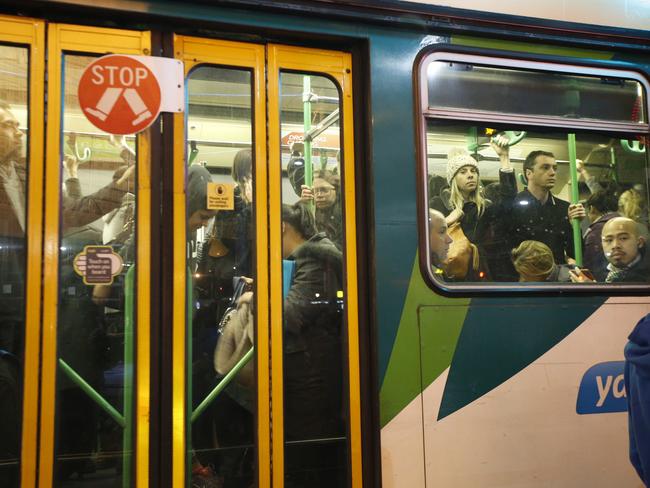 A packed tram outside Flinders Street Station. Picture: David Caird