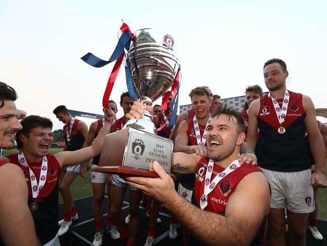 Demons premiership player Dan Green celebrates winning the 2019 QAFL grand final. Photo: Jason O'Brien Photography