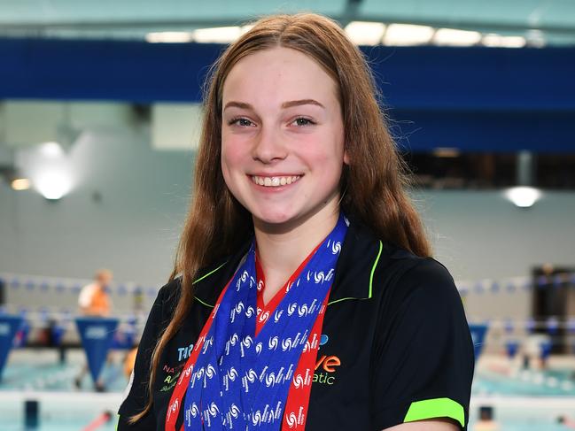 Tess Haslam (let) and Tara Kinder pose for a photograph with there swimming and water polo medals at the Watermarc centre in Greensborough, Melbourne, Thursday, February 1, 2018. The two girls have won a number of medals. (AAP Image/James Ross) NO ARCHIVING