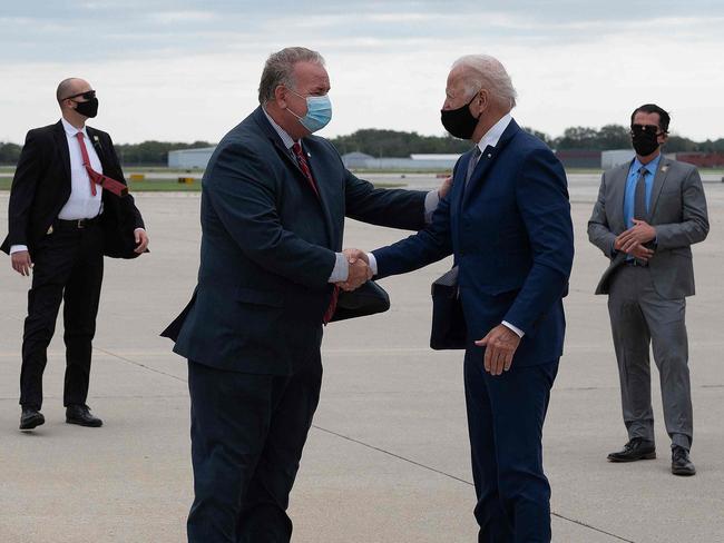 Democratic presidential candidate Joe Biden on Thursday flouted COVID-19 social distancing norms and shook hands with an aide on the tarmac as he arrived in Wisconsin