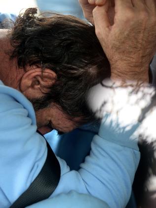 Roman Heinze in the back of a police car after his arrest in February last year.