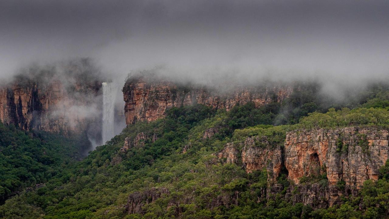 Kakadu National Park comes alive during the wet season. Kakadu Air are celebrating their 40th anniversary of flying in the Territory and relish the opportunity to show the NT News a new perspective of the park after rainfall. Jim Jim Falls is shrouded in cloud in the morning light. Picture: Che Chorley