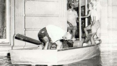 Saving precious items from the School of Arts, Maryborough, in the 1955 flood. Residents rescue valuable belongings from the School of Arts amid rising waters. Source: Unknown