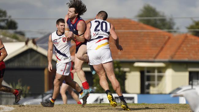 SFL: Chelsea Heights’ Jordan Perryman cops a bump. Picture: Valeriu Campan