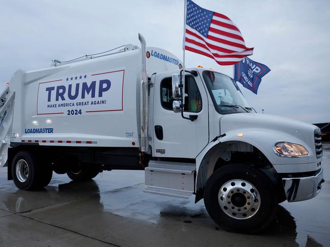 GREEN BAY, WISCONSIN - OCTOBER 30: A garbage truck is is decked out with campaign signs and flags for Republican presidential nominee, former President Donald Trump on the tarmac at Green Bay Austin Straubel International Airport on October 30, 2024 in Green Bay, Wisconsin. With less than a week until Election Day, Trump continues to campaign in the battleground swing states.   Chip Somodevilla/Getty Images/AFP (Photo by CHIP SOMODEVILLA / GETTY IMAGES NORTH AMERICA / Getty Images via AFP)