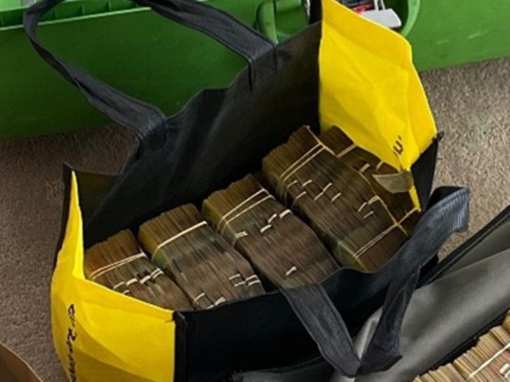 More than $2 million in cash and cryptocurrency seized from a home by the AFP following a money laundering investigation on the Gold Coast. Picture: AFP