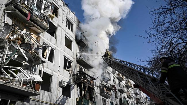 Firefighters work on a fire on a building after bombings on the eastern Ukraine town of Chuguiv on Thursday. Picture: AFP