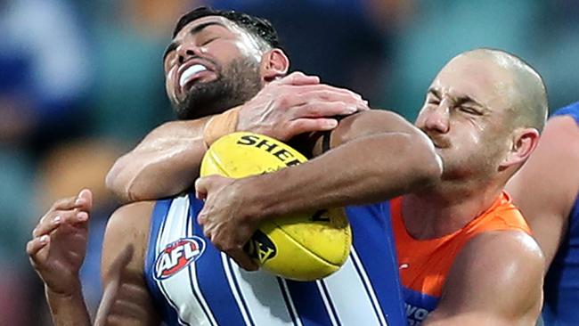 HOBART, AUSTRALIA - JUNE 13: Tarryn Thomas of the Kangaroos is tackled by Shane Mumford of the Giants during the round 13 AFL match between the North Melbourne Kangaroos and the Greater Western Sydney Giants at Blundstone Arena on June 13, 2021 in Hobart, Australia. (Photo by Mark Metcalfe/AFL Photos/via Getty Images)