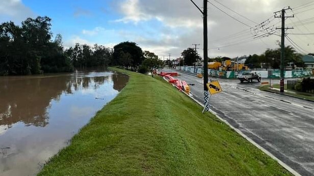 Water laps at the levee bank on the Pacific Highway at Maclean on Tuesday afternoon. Picture: Newcastle SES