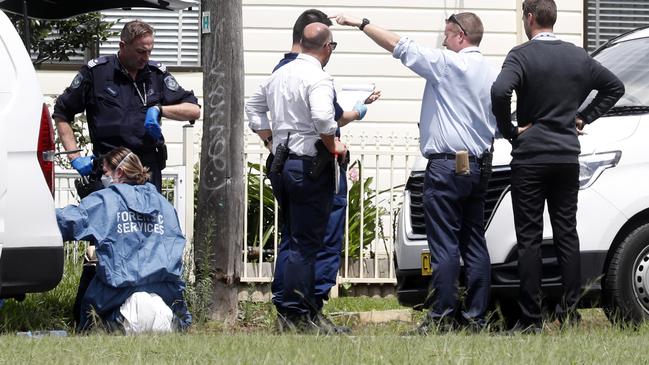 Police collecting evidence outside the home on Acacia Avenue in St Marys. Picture: Jonathan Ng