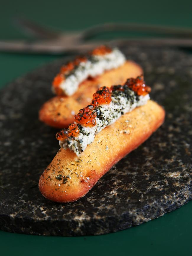 Smoked eel on brioche with roe and seaweed.