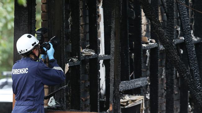 Fire investigators at the scene of the blaze. Picture: David Crosling