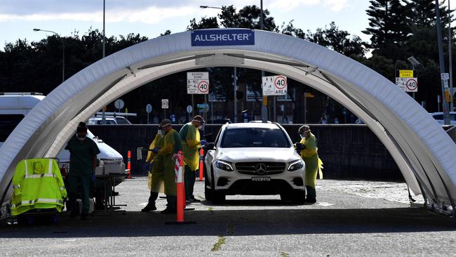 Medics perform COVID-19 tests at a drive-through testing center at Bondi Beach. Picture: AFP