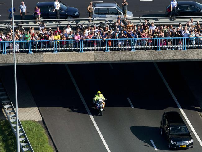 Mourners look over a bridge at the convoy of hearses carrying the bodies of victims MH17 in the Netherlands. Picture: Jerry Lampen