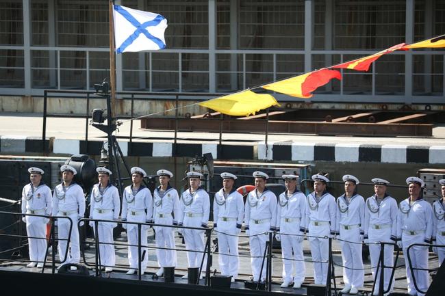 Sailors stand at attention on the deck of a Russian Black Sea Fleet warship during the Navy Day celebrations in Novorossiysk