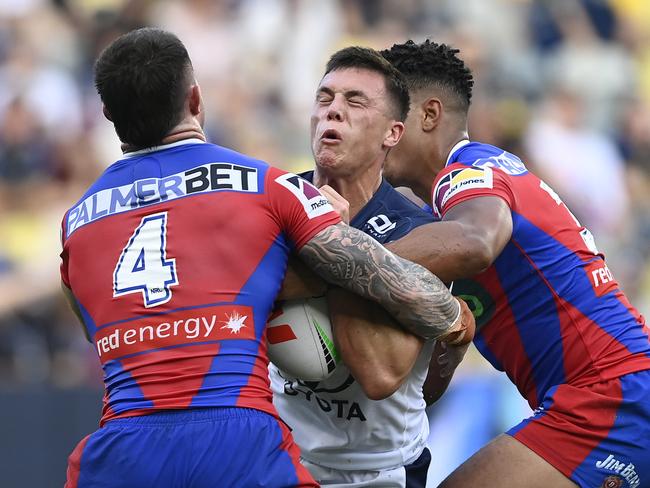 Scott Drinkwater is stopped by the Newcastle Knights defence. Picture: Getty Images