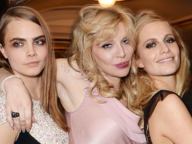 LONDON, ENGLAND - DECEMBER 01: (L to R) Karlie Kloss, Model of the Year winner Cara Delevingne, Courtney Love, Poppy Delevingne and Joan Smalls attend the British Fashion Awards at the London Coliseum on December 1, 2014 in London, England. (Photo by David M. Benett/Getty Images)