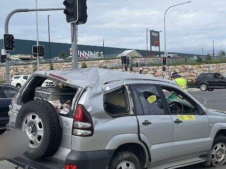 A car flipped in a two-vehicle crash at a busy intersection outside Kawungan Bunnings on Sunday, November 26, 2023. Picture: Adam Miller