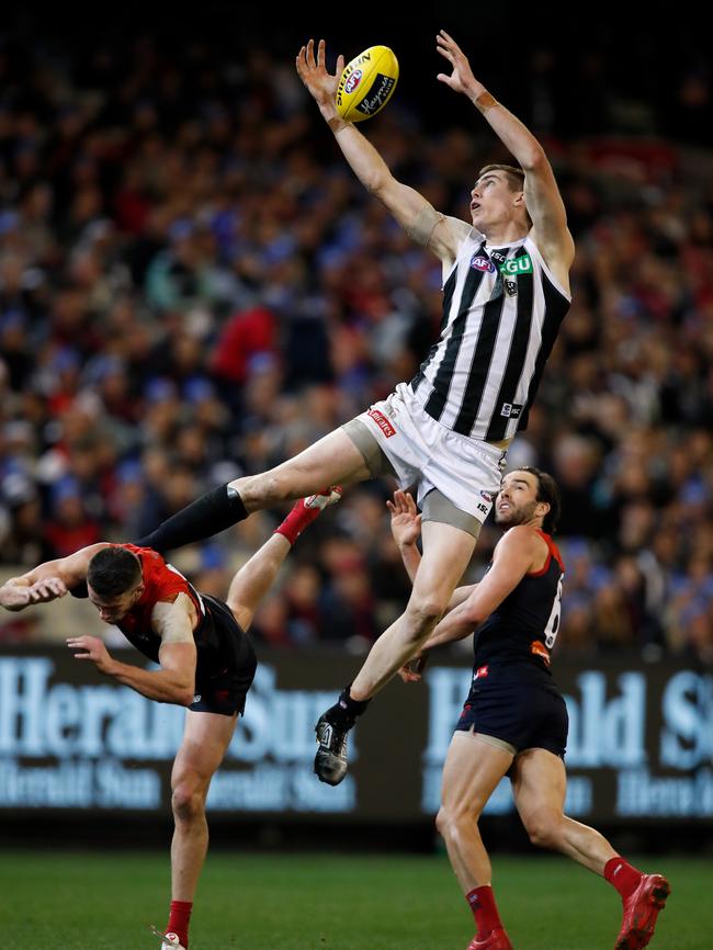 Mason Cox of the Magpies attempts to mark over Demons Joel Smith and Jordan Lewis on Monday. Picture: Adam Trafford/AFL Media/Getty Images