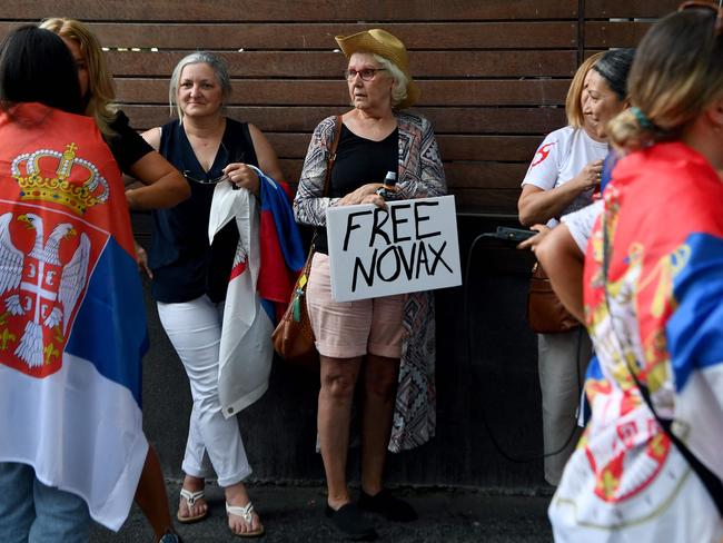 Members of the local Serbian community gather outside a hotel where Serbia's tennis champion Novak Djokovic is reported to be detained in Melbourne. Picture: AFP