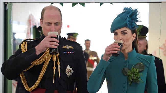 Thirsty work: The royal couple both sink a Guinness. Picture: POOL / AFP