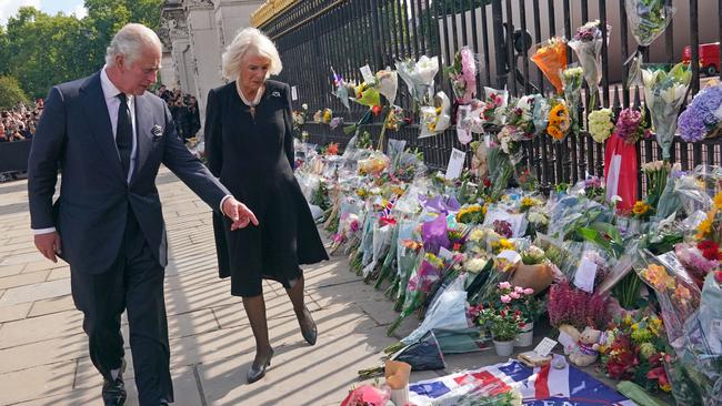 King Charles III and Camilla, Queen Consort, view tributes outside Buckingham Palace on Friday. Picture: Getty.