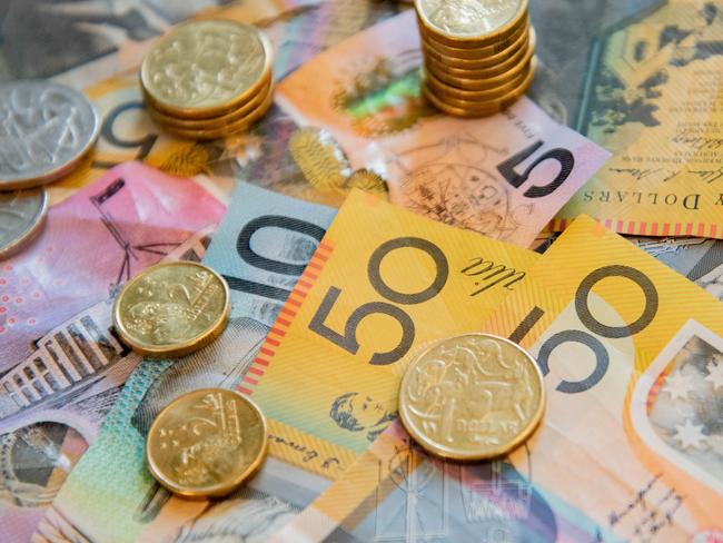 Australian notes and coins spilled out on a table