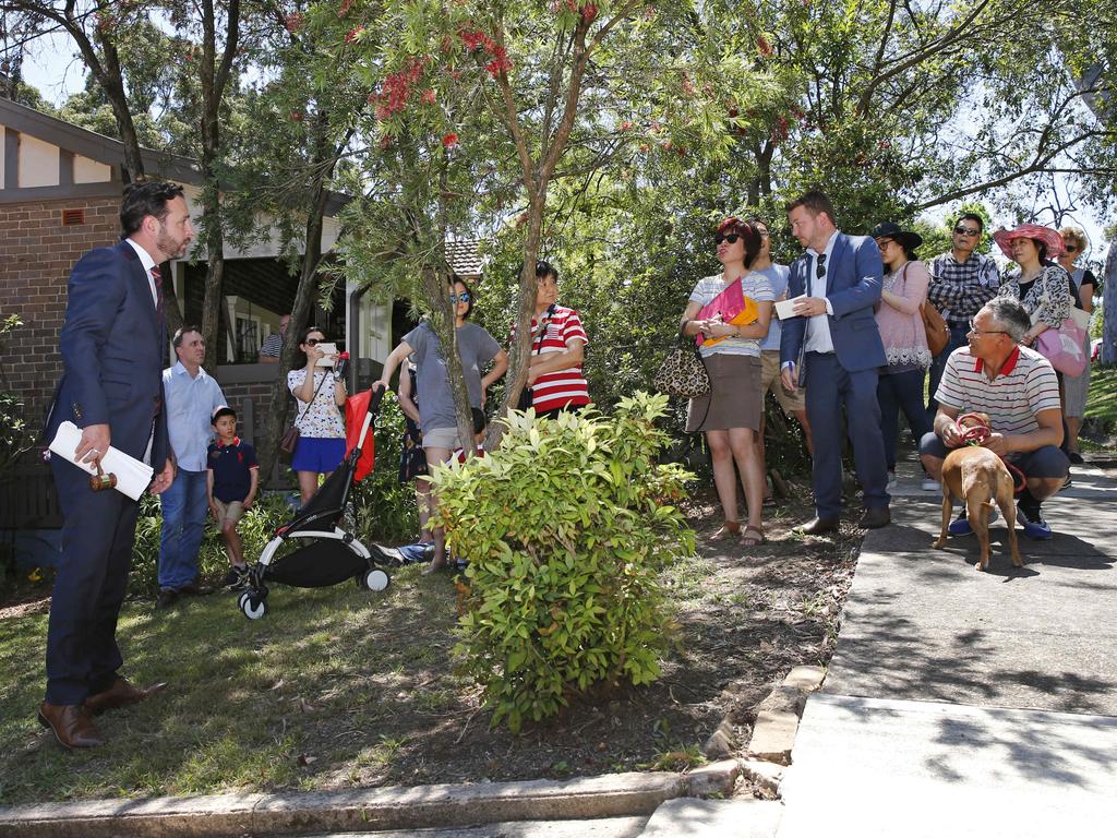 Auctioneer Ben Mitchell addresses the small crowd that had gathered in the street for the auction. Picture: Richard Dobson