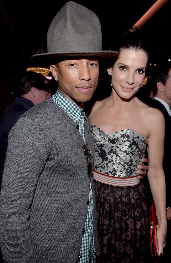 Pharrell Williams, Sandra Bullock, and a Very Big Hat. Getty Images