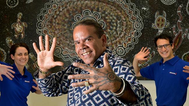 Arist Stan Yarramunua with Officeworks Fitzroy staff, Eleanor Weber and Mick Porter, in front of one of his works.  Picture: ...