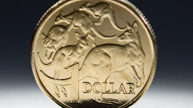 An Australian one-dollar coin is arranged for a photograph in Sydney, Australia, on Wednesday, April 17, 2013. Direct trading between the Australian dollar and yuan started on April 10. Photographer: Ian Waldie/Bloomberg