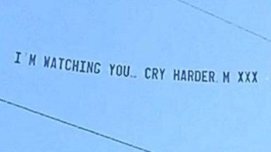 The cheeky banner Michelle Neumann arranged to be towed behind a plane at her own funeral. Pic: Mike Perry