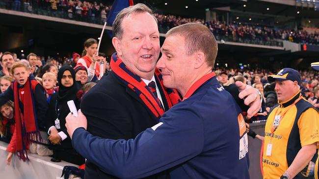 Melbourne president Glen Bartlett and coach Simon Goodwin embrace as the Demons cement their place in the 2018 finals with a round 23 win over the Giants at the MCG.