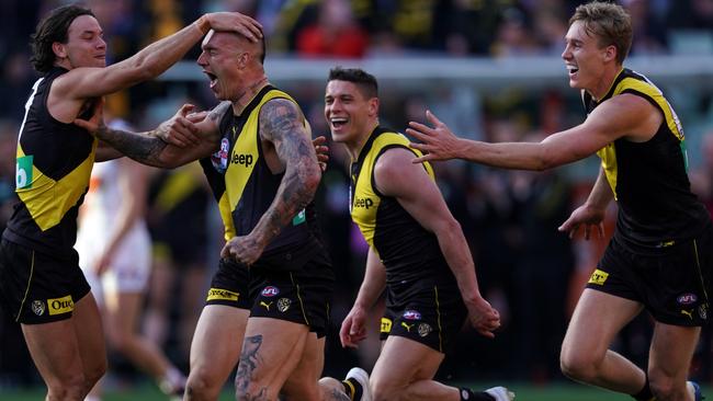 Dusty celebrates with the boys after a final-term goal. Picture: AAP