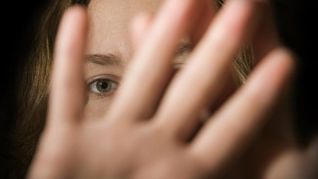 A woman's hands in front of her face. domestic violence generic