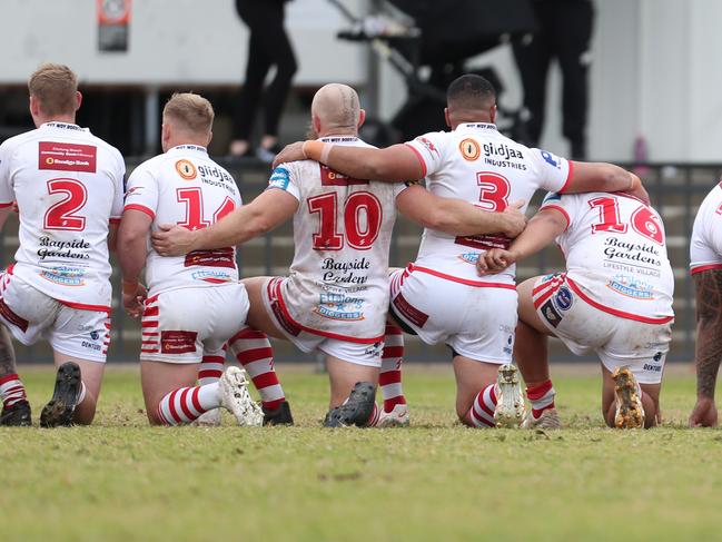 Woy Woy Roosters take a knee against Dora Creek Swampies. Picture: Sue Graham