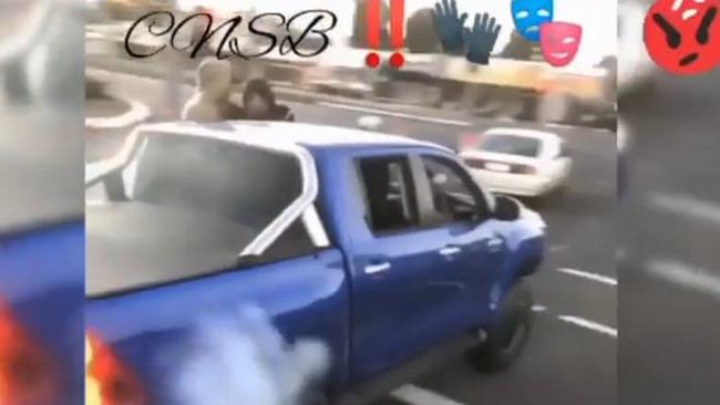 Alleged car thieves in a Toyota HiLux do burnouts and run a red light outside Pillow Talk last year.