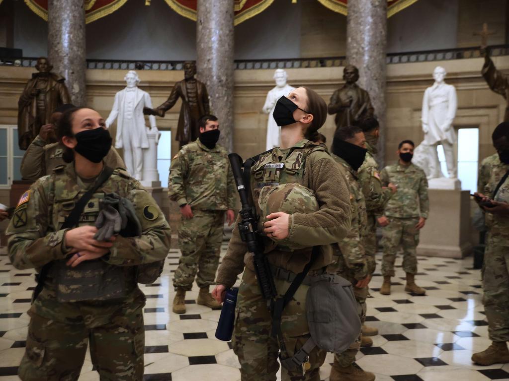 Exactly one week after a violent mob stormed through the US Capitol, members of the Virginia National Guard tour Statuary Hall. Picture: Chip Somodevilla/Getty Images/AFP