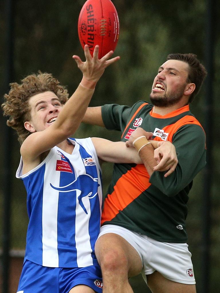 Essendon District: Zac Taylor of Oak Park juggles the ball in front of Keilor Park’s Jake Gatto. Picture: Hamish Blair