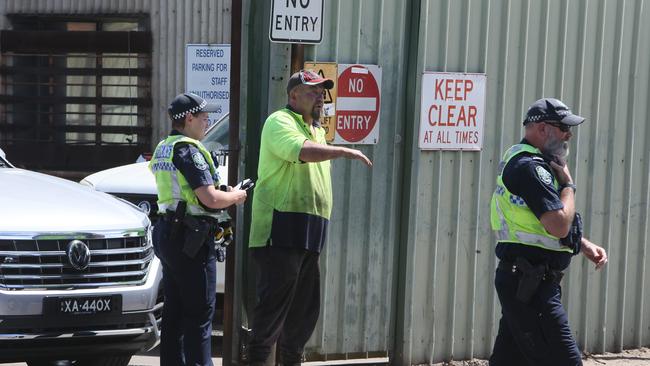 Police speaking to Denron Metals employees after Craig Hatchard was struck twice by Shane Matherson. Picture: Emma Brasier