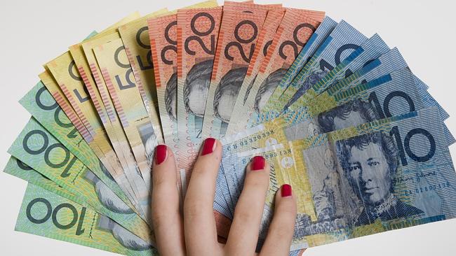 Australian $100, $50, $20 and $10 notes form a fan in woman's hand. 
