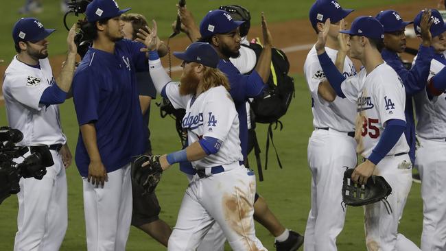 Los Angeles Dodgers' Justin Turner is congratulated after Game 1 of baseball's World Series against the Houston Astros.