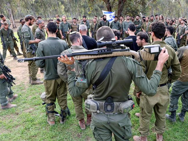 Israeli soldiers gather on December 17 at the abandoned site of the Supernova music festival after the attack by Hamas militants on October 7, near Kibbutz Reim in southern Israel. Picture: AFP