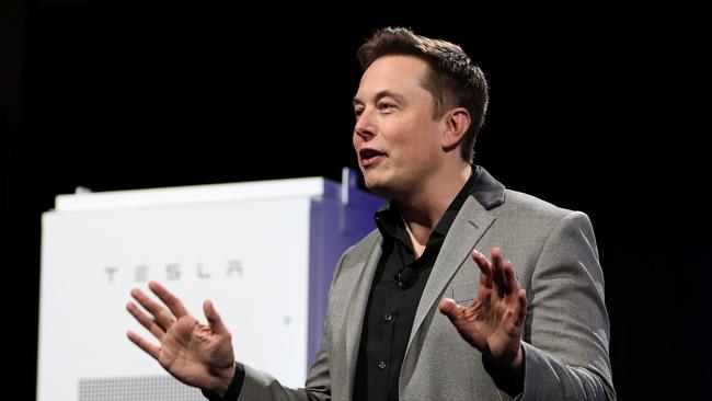 This file photo taken on May 1, 2015 shows Tesla Motors CEO Elon Musk unveiling large utility scale home batteries at the Tesla Design Studio in Hawthorne, California. AFP PHOTO / DAVID MCNEW