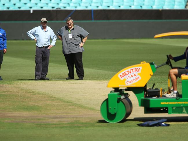 Head groudsman Tom Parker with Andy Atkinson from ICC check the pitch at the SCG ahead of World Cup Semi Final between Australia and India. pic. Phil Hillyard