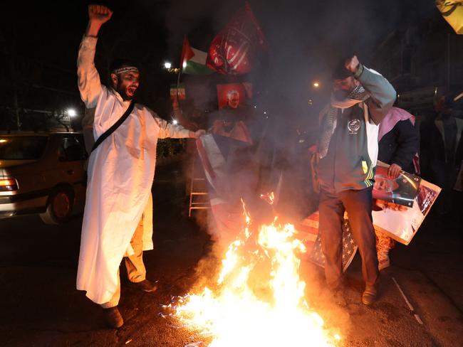 Iranian protesters burn an Israeli and a US flag during a demonstration in solidarity with the Palestinian people and Iran-backed Yemeni rebels following US and British forces strikes on Houthi rebel-held cities in Yemen, in front of the British embassy in Tehran. Picture: